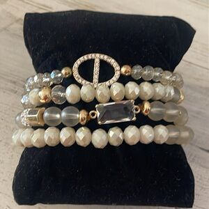 Off White/Smoky Beaded Four Strand Stretchy Gem/Charm Bracelet.